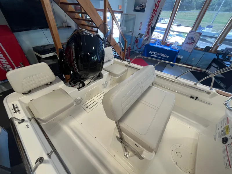 Slide: The Image of Interior view of a Boston Whaler 170 Montauk with white seating and an outboard motor. - 4