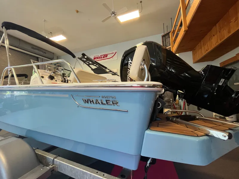 Slide: The Image of A 2026 Boston Whaler 170 Montauk is on a trailer indoors. - 16