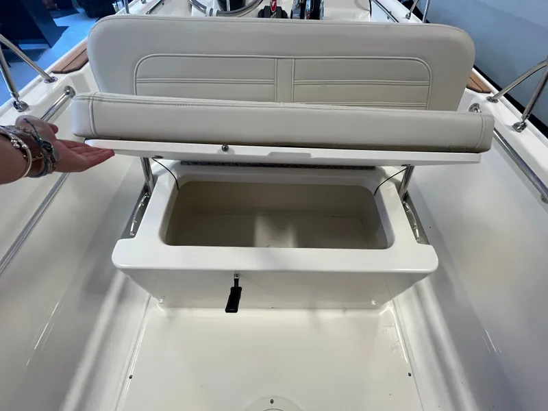 Slide: The Image of An open storage compartment on a boat with a cushioned seat lid. - 8
