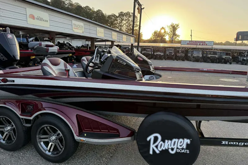 Slide: The Image of 2018 Ranger Z520L boat at dealership, sunset in background. - 1