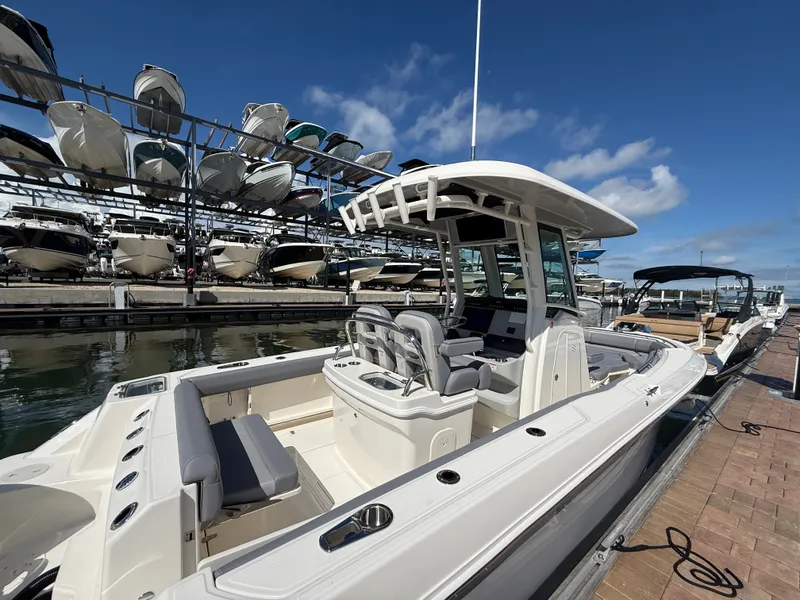 Slide: The Image of A 2027 Boston Whaler 250 Outrage at the dock, featuring a spacious deck and modern amenities. - 29