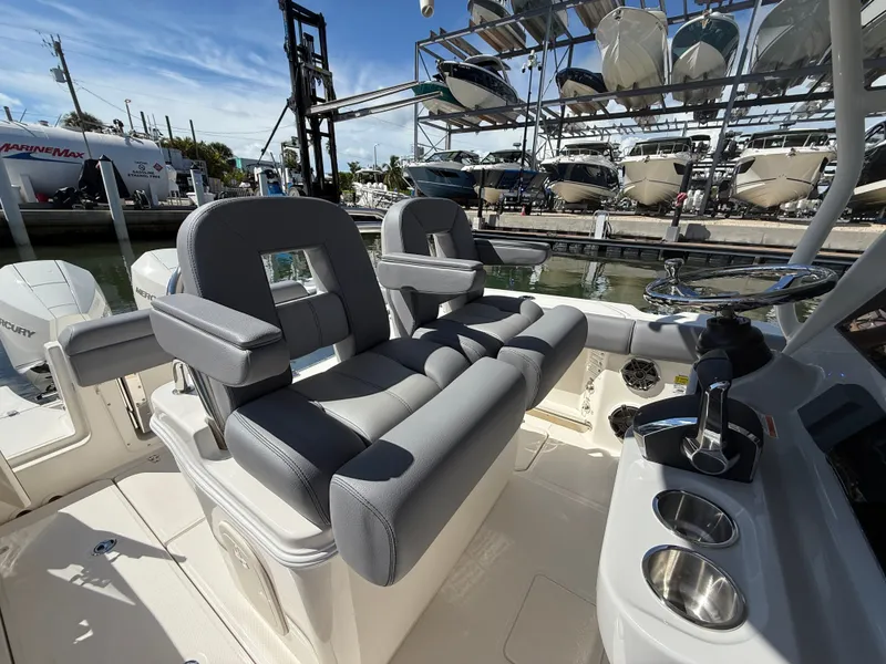 Slide: The Image of The image shows the cockpit of a Boston Whaler 250 Outrage with gray cushioned seats and helm. - 19