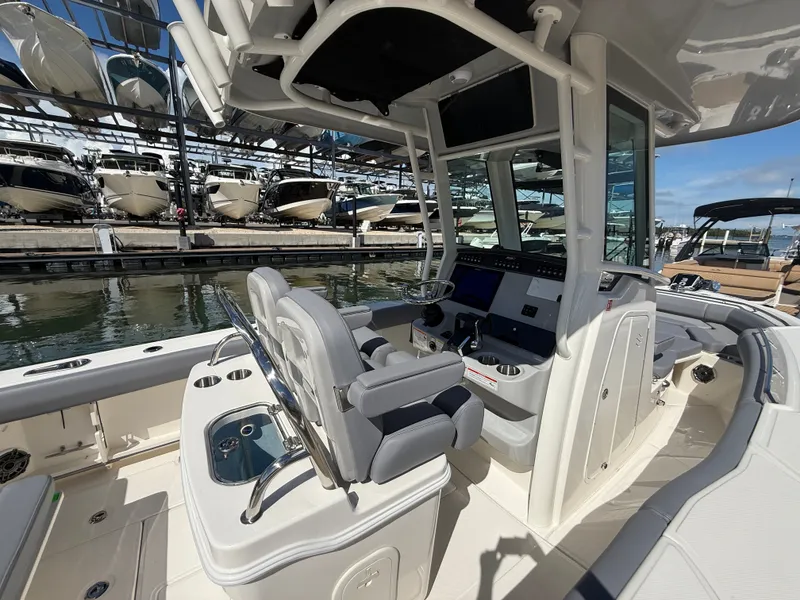 Slide: The Image of The image shows the cockpit of a Boston Whaler 250 Outrage with modern controls and comfortable seating. - 30
