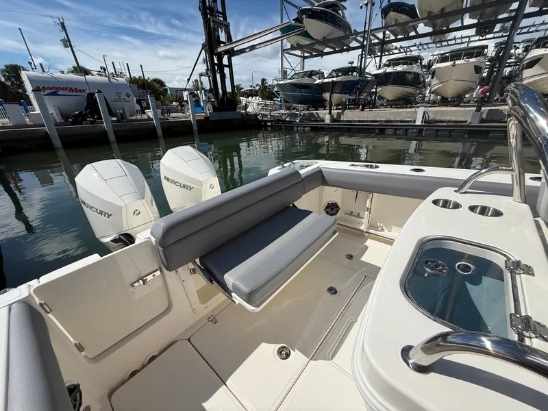 Slide: The Image of The image shows the stern of a Boston Whaler 250 Outrage with two Mercury engines and a seating area. - 26