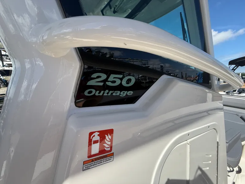 Slide: The Image of Close-up of a white Boston Whaler 250 Outrage with a safety sticker. - 16
