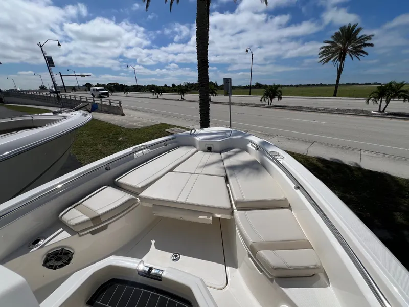Slide: The Image of The image shows the bow of a Boston Whaler 280 Dauntless with beige cushions and a clear sky. - 34