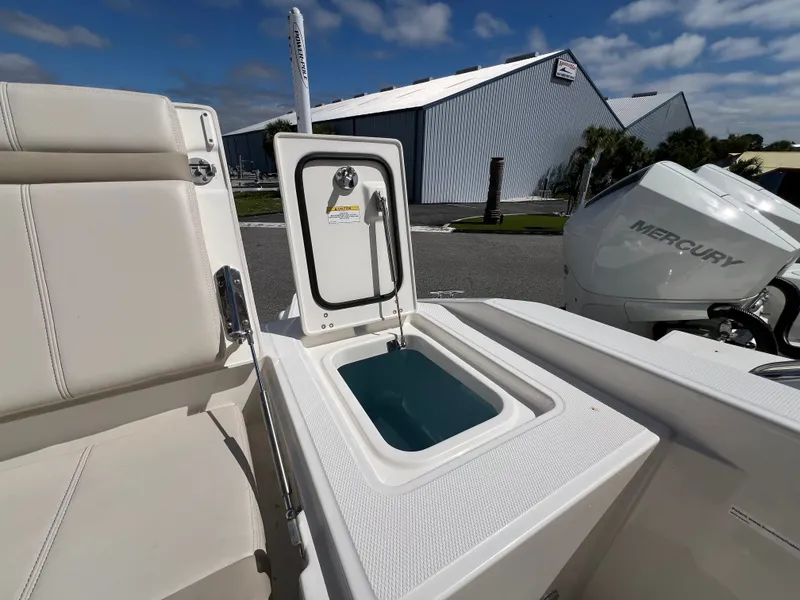 Slide: The Image of The image shows the cockpit of a Boston Whaler 280 Dauntless with an open storage compartment. - 19
