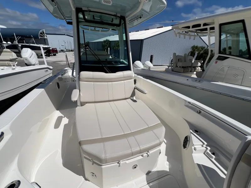 Slide: The Image of The image shows the cockpit of a 2027 Boston Whaler 280 Dauntless with white upholstery. - 24