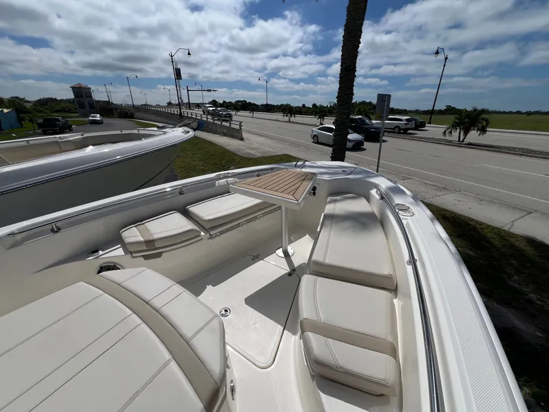 Slide: The Image of The image shows the bow of a Boston Whaler 280 Dauntless with seating and a table. - 41