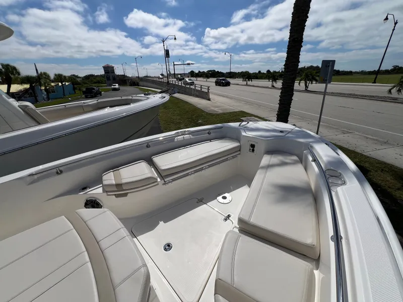 Slide: The Image of The image shows the deck of a 2027 Boston Whaler 280 Dauntless with seating and storage. - 30