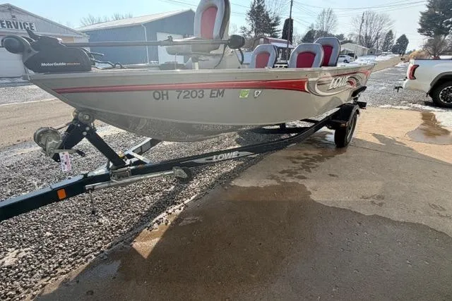 Slide: The Image of 2009 Lowe Fishing Machine 165 on trailer, parked outdoors, with visible registration number. - 8