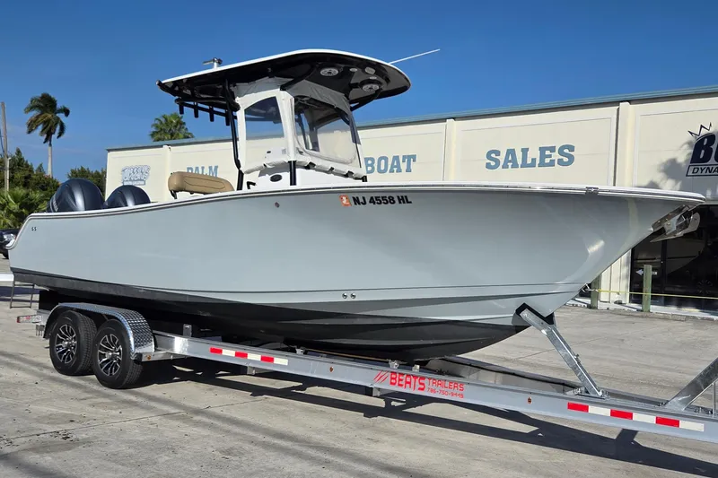 The Image of 2018 Sportsman Open 252 Center Console boat on trailer at dealership. - 0