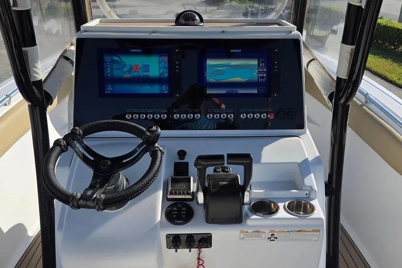 Slide: The Image of 2018 Sportsman Open 252 Center Console dashboard with dual Simrad displays and steering wheel. - 11