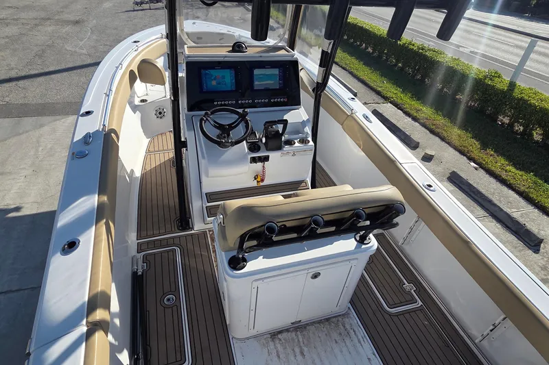 Slide: The Image of 2018 Sportsman Open 252 Center Console boat interior with dual screens and seating. - 14