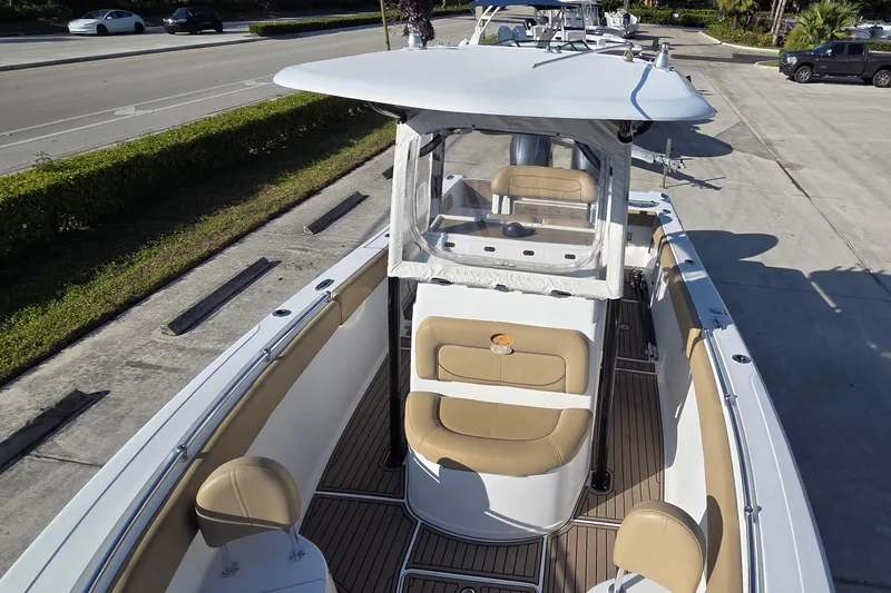 Slide: The Image of 2018 Sportsman Open 252 Center Console boat with tan seating and sleek design. - 3