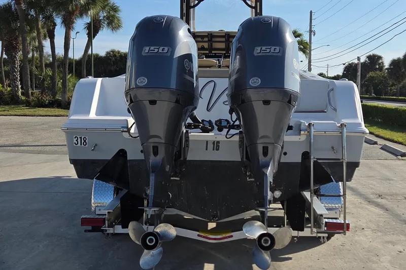 Slide: The Image of 2018 Sportsman Open 252 Center Console with dual outboard motors, rear view. - 4