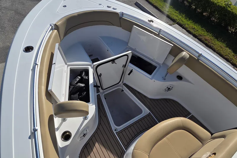 Slide: The Image of 2018 Sportsman Open 252 Center Console boat interior with storage compartments and seating. - 7
