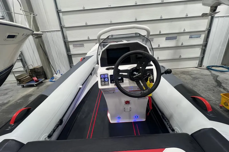 Slide: The Image of 2025 Highfield Velox 420 boat interior with steering wheel and control panel. - 11