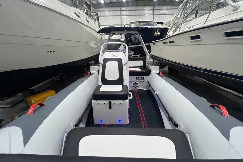 Slide: The Image of 2025 Highfield Velox 420 boat interior in a showroom, surrounded by larger yachts. - 16