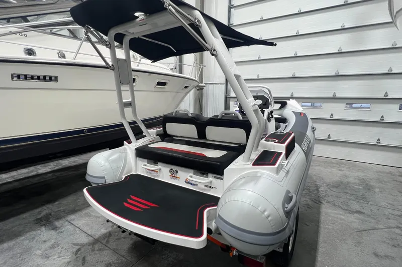 Slide: The Image of 2025 Highfield Velox 420 boat in a garage, featuring sleek design and modern seating. - 4