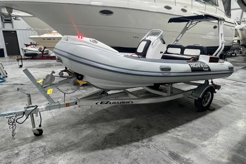 Slide: The Image of 2025 Highfield Velox 420 inflatable boat on trailer in a showroom. - 6