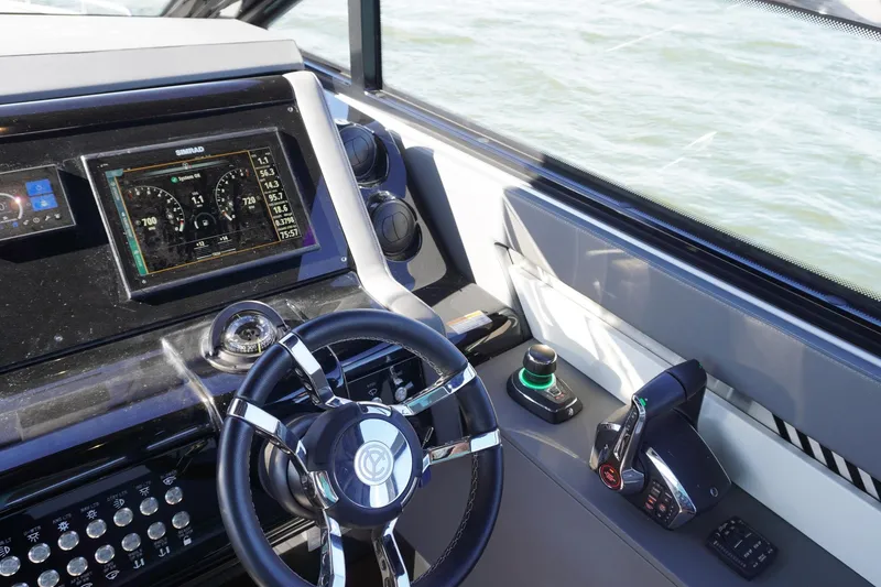 Slide: The Image of 2023 Cruisers Yachts 42 GLS OB helm with advanced navigation controls and display. - 16