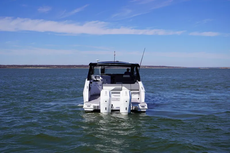 Slide: The Image of 2023 Cruisers Yachts 42 GLS OB on open water, rear view. - 3