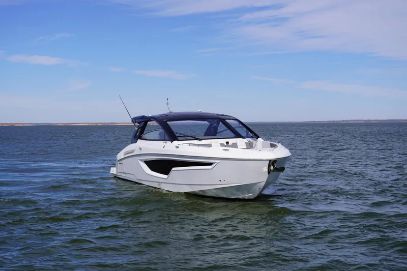 Slide: The Image of 2023 Cruisers Yachts 42 GLS OB on open water under clear blue sky. - 4