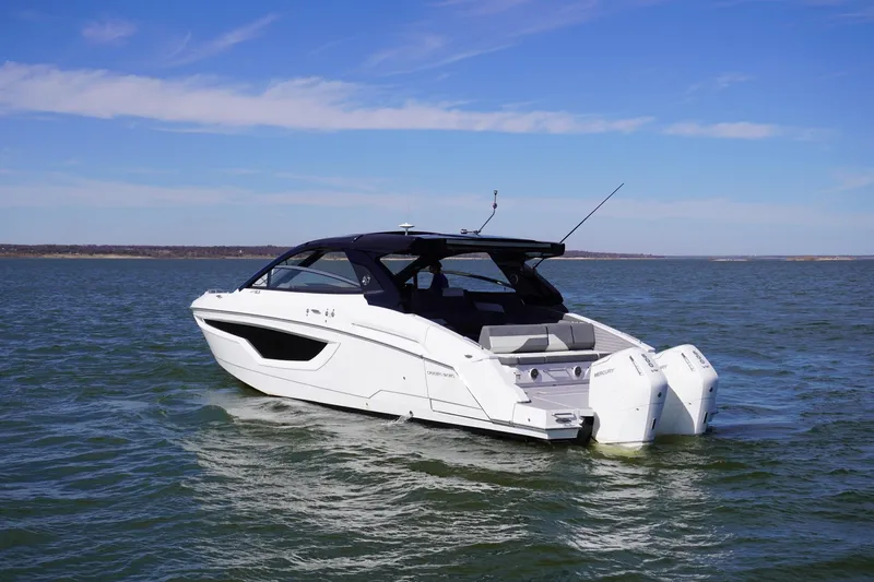 Slide: The Image of 2023 Cruisers Yachts 42 GLS OB on open water, showcasing sleek design and powerful outboard engines. - 5