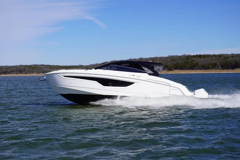Slide: The Image of 2023 Cruisers Yachts 42 GLS OB cruising on open water under clear skies. - 6