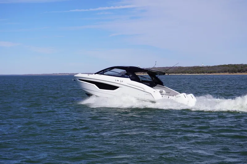 Slide: The Image of 2023 Cruisers Yachts 42 GLS OB cruising on open water under clear skies. - 7