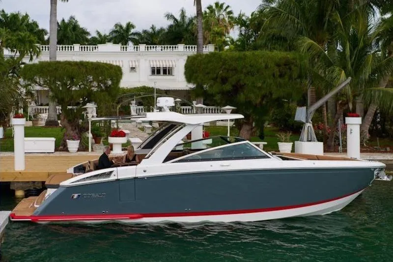 The Image of 2026 Cobalt R33 boat docked by a luxurious waterfront estate. - 1