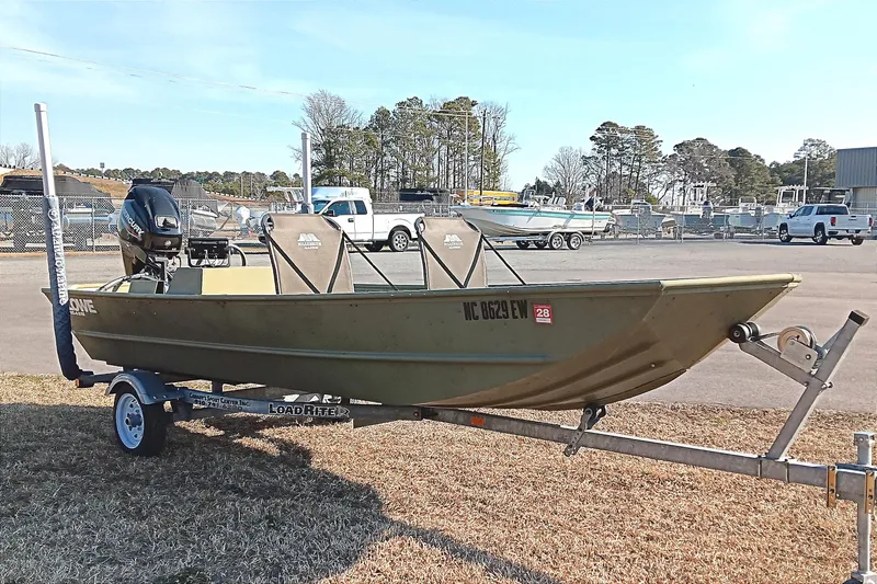 Slide: The Image of 2022 Lowe L1648M Jon boat on trailer, parked outdoors. - 5