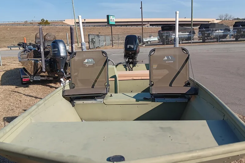 Slide: The Image of 2022 Lowe L1648M Jon boat with Yamaha outboard motor, parked outdoors. - 8