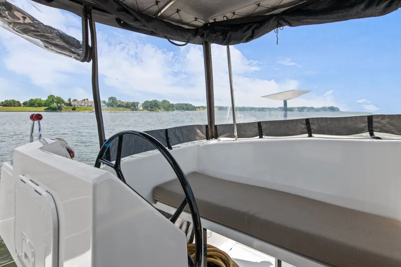 Slide: The Image of Fountaine Pajot Astrea 42 catamaran cockpit with water view. - 44