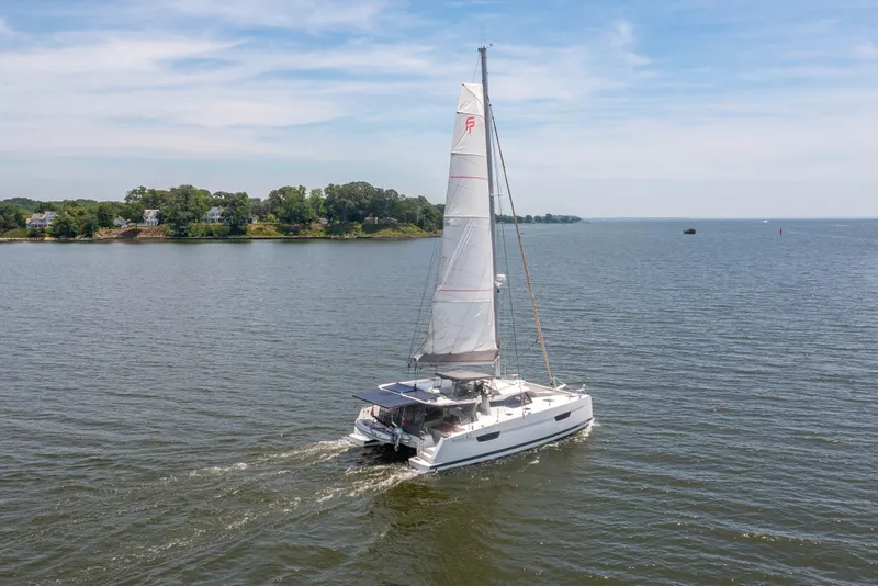 Slide: The Image of 2019 Fountaine Pajot Astrea 42 catamaran sailing on calm waters. - 8