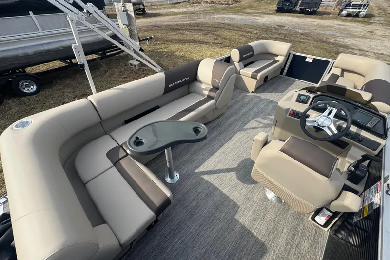 Slide: The Image of 2026 Bennington 20 SL pontoon boat interior with beige seating and modern helm. - 13