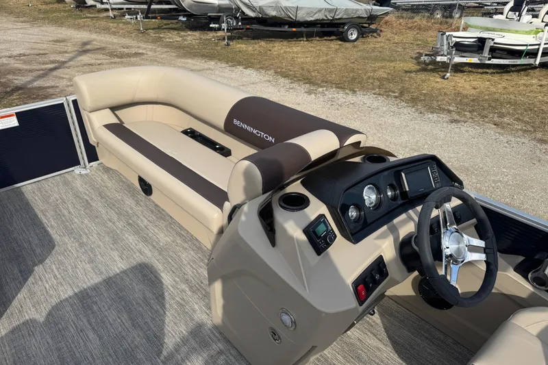 Slide: The Image of 2026 Bennington 20 SL boat interior with beige seating and modern dashboard. - 9