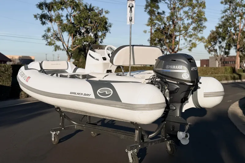 Slide: The Image of 2021 Walker Bay Generation 10 LTE boat with Yamaha 20 outboard motor on a trailer. - 18