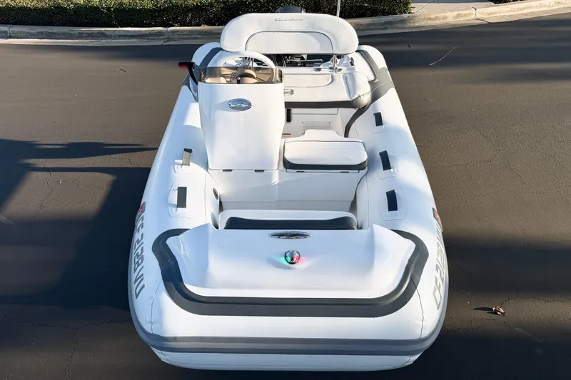 Slide: The Image of 2021 Walker Bay Generation 10 LTE inflatable boat, white with seating and steering console. - 19
