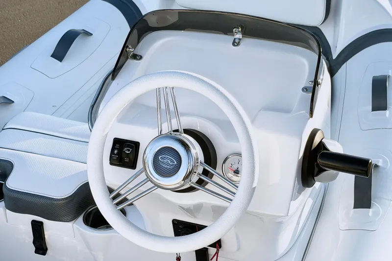 Slide: The Image of Steering console of 2021 Walker Bay Generation 10 LTE boat, featuring sleek design and controls. - 22
