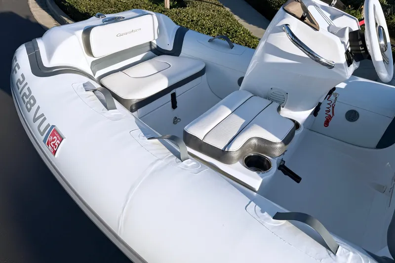 Slide: The Image of 2021 Walker Bay Generation 10 LTE boat interior with white seating and steering console. - 3