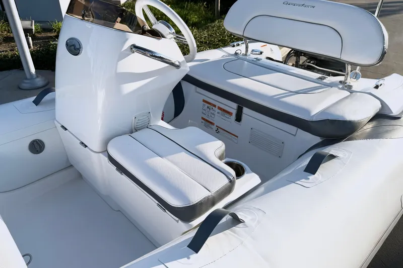 Slide: The Image of 2021 Walker Bay Generation 10 LTE boat interior with white seating and steering console. - 4