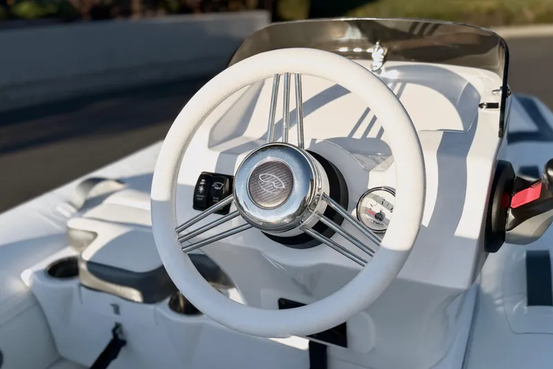 Slide: The Image of 2021 Walker Bay Generation 10 LTE boat steering wheel and dashboard close-up. - 7