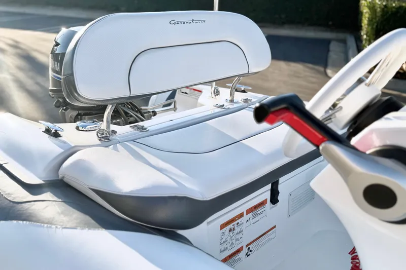 Slide: The Image of 2021 Walker Bay Generation 10 LTE boat interior with white seating and control panel. - 8