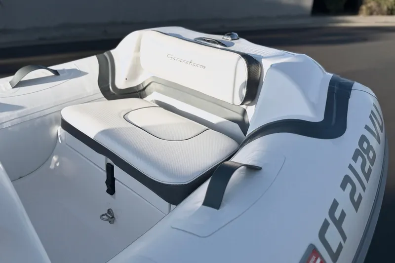 Slide: The Image of 2021 Walker Bay Generation 10 LTE boat interior with cushioned seating and sleek design. - 9