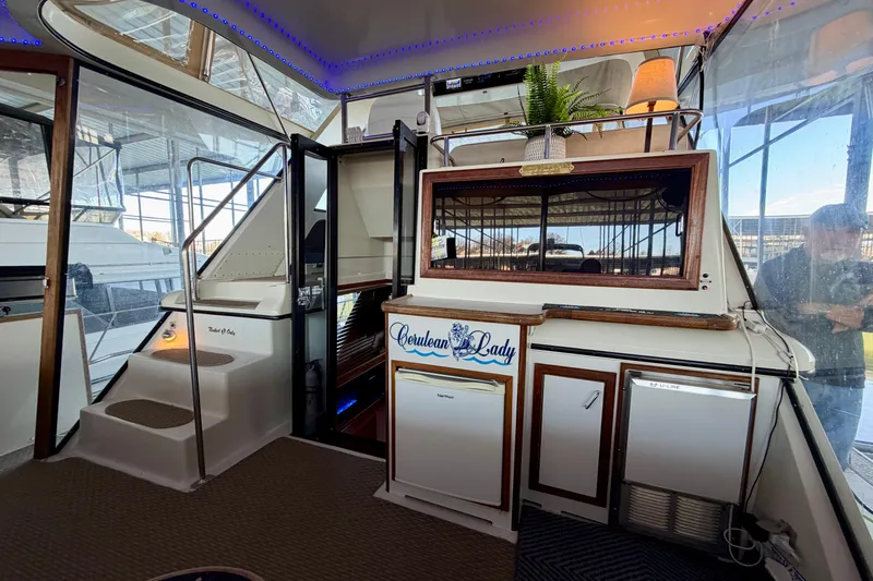 Slide: The Image of 1987 Carver 4207 Aft Cabin Motor Yacht interior with stairs, cabinets, and decorative lighting. - 13