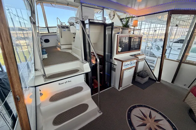 Slide: The Image of 1987 Carver 4207 Aft Cabin Motor Yacht interior with helm and seating area. - 15