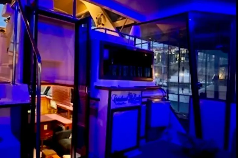 Slide: The Image of 1987 Carver 4207 Aft Cabin Motor Yacht interior with blue ambient lighting. - 16