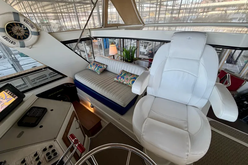 Slide: The Image of Interior of 1987 Carver 4207 Aft Cabin Motor Yacht with white seating and nautical decor. - 19